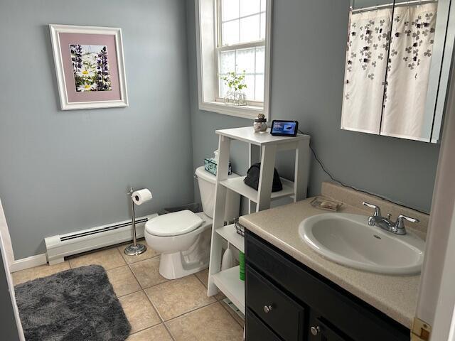 bathroom featuring a baseboard radiator, tile patterned floors, toilet, and vanity