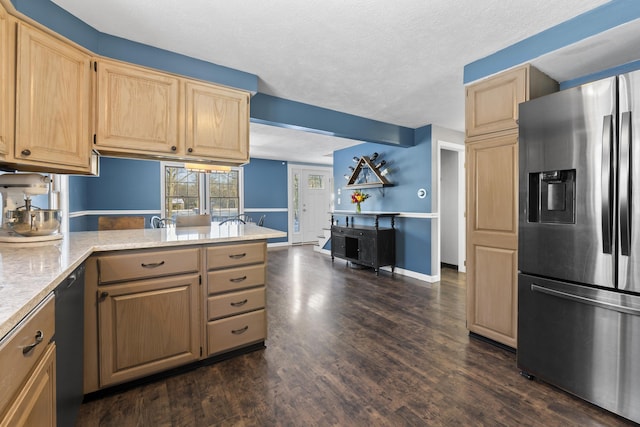 kitchen featuring dark hardwood / wood-style floors, stainless steel fridge, light brown cabinetry, and a textured ceiling