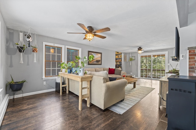 living room featuring a baseboard heating unit, dark hardwood / wood-style floors, and ceiling fan