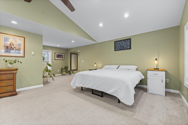 bedroom with ceiling fan, light colored carpet, and high vaulted ceiling