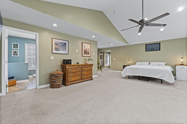 carpeted bedroom with multiple windows, high vaulted ceiling, ceiling fan, and ensuite bathroom