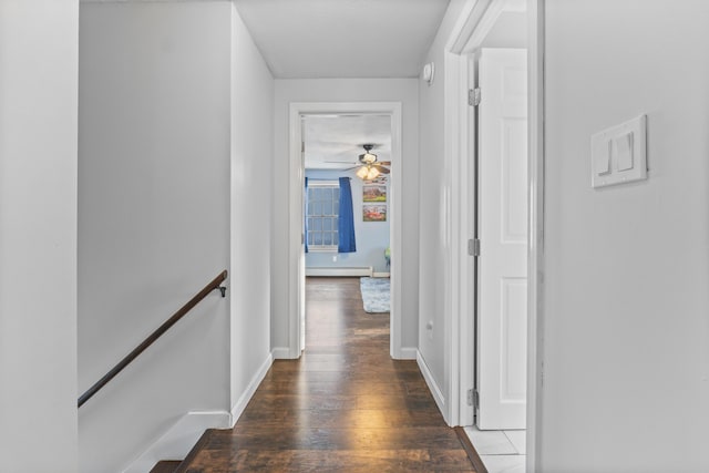 hall with dark hardwood / wood-style flooring and a baseboard radiator