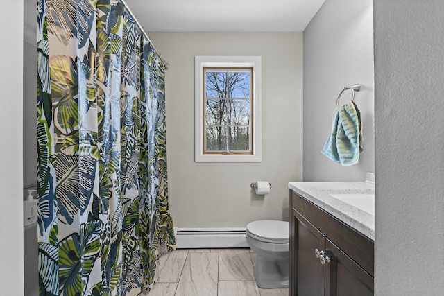 bathroom with baseboard heating, vanity, and toilet