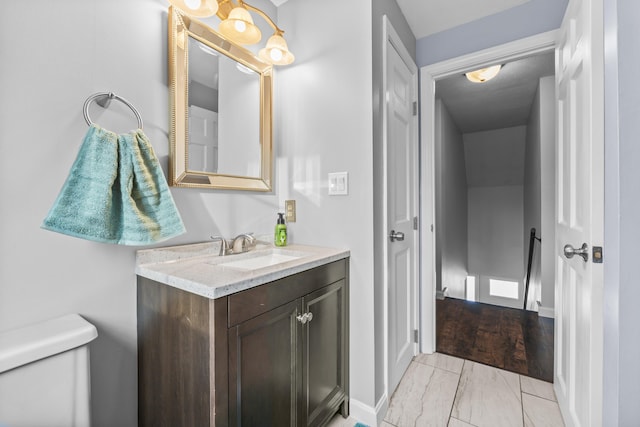 bathroom featuring vanity and toilet