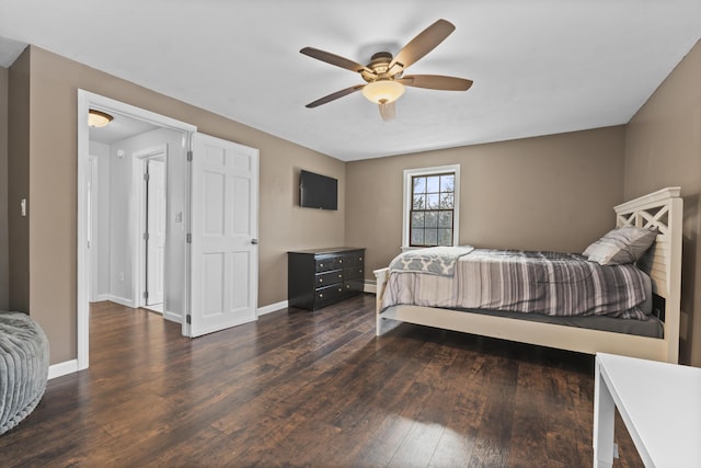 bedroom with a baseboard heating unit, dark hardwood / wood-style floors, and ceiling fan