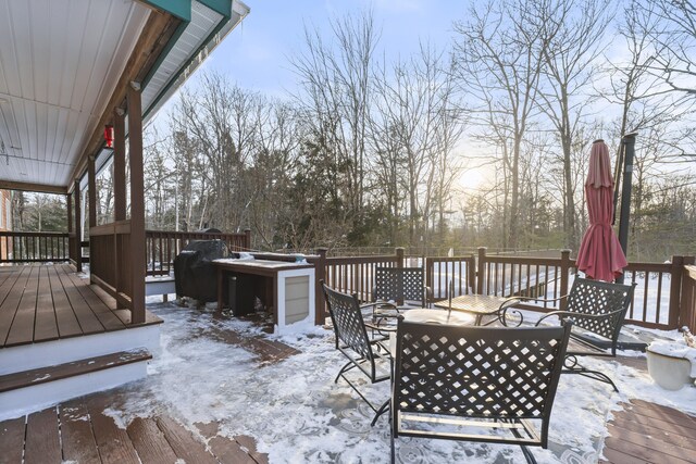 snow covered deck with an outdoor living space