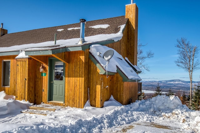 view of snow covered exterior featuring a mountain view