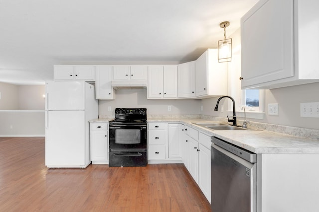 kitchen featuring sink, white refrigerator, black / electric stove, dishwasher, and pendant lighting