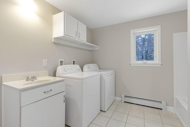 laundry room featuring light tile patterned flooring, sink, cabinets, baseboard heating, and independent washer and dryer