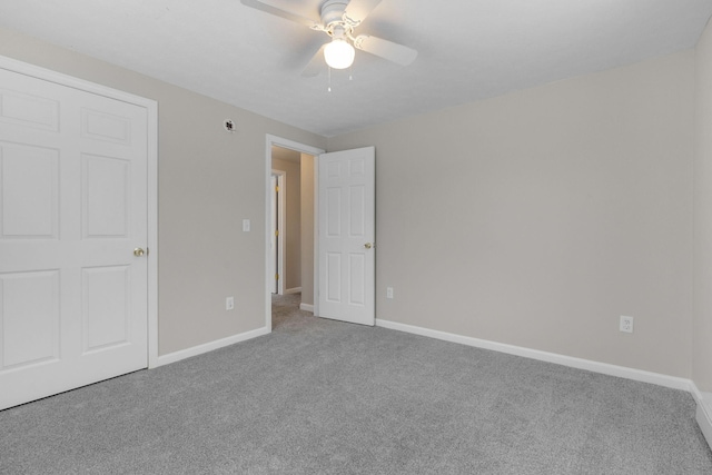 unfurnished bedroom featuring ceiling fan and carpet