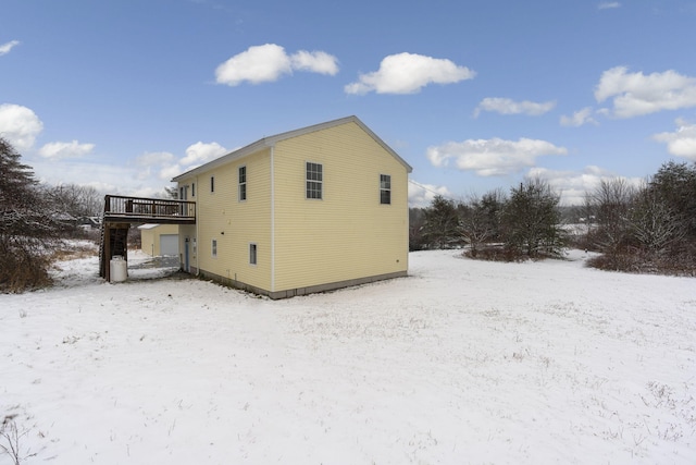 snow covered property featuring a wooden deck