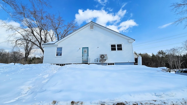 snow covered property featuring ac unit