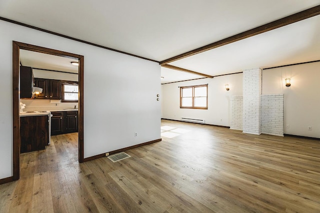 unfurnished living room with sink, crown molding, a baseboard heating unit, beam ceiling, and light wood-type flooring