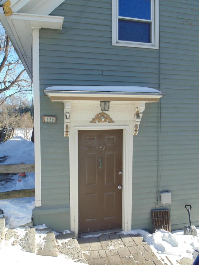 view of snow covered property entrance