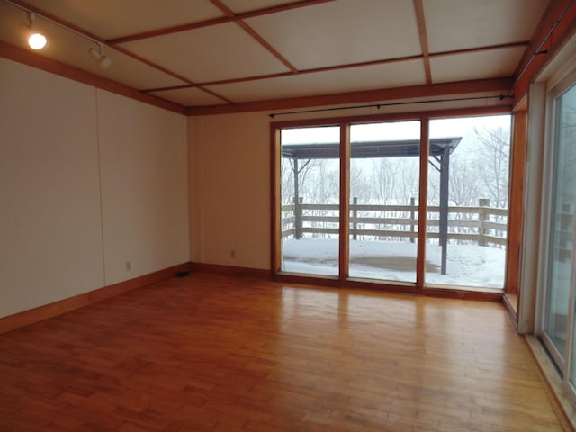 spare room with light wood-type flooring and baseboards