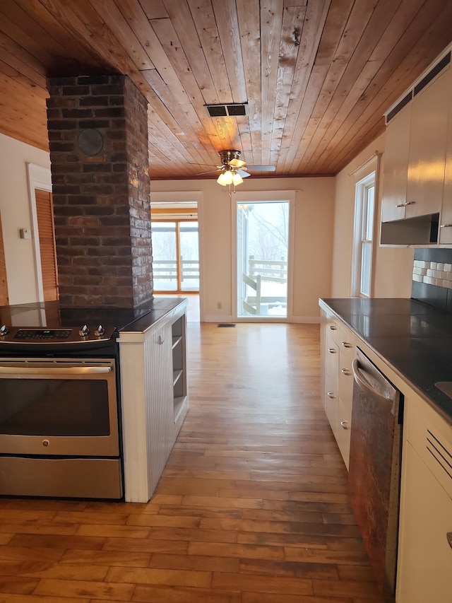 kitchen featuring dark countertops, light wood-style flooring, appliances with stainless steel finishes, wood ceiling, and white cabinets