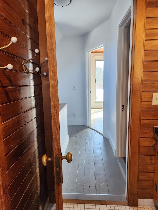 hallway featuring baseboards and wood finished floors