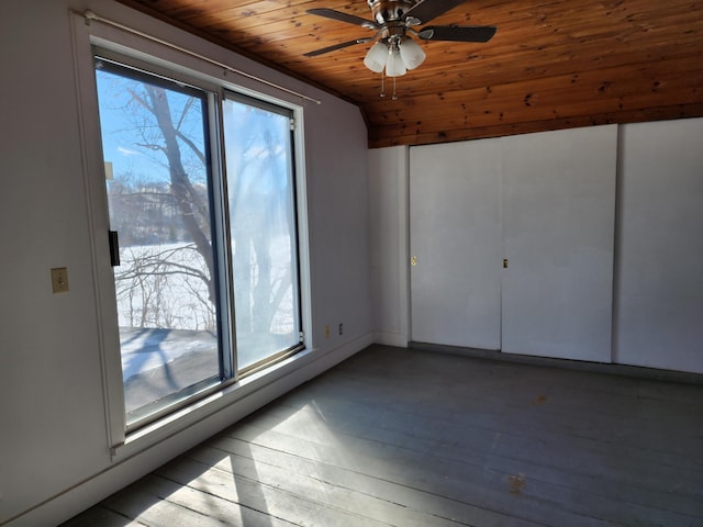 interior space featuring wooden ceiling, wood-type flooring, a ceiling fan, and a wealth of natural light