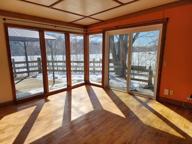 doorway to outside featuring hardwood / wood-style flooring and baseboards