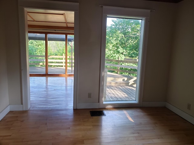 329 Hancock St, Bangor, ME 04401 - doorway to outside featuring baseboards and wood finished floors