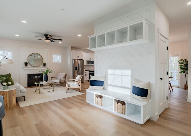 living room with ceiling fan and light hardwood / wood-style floors