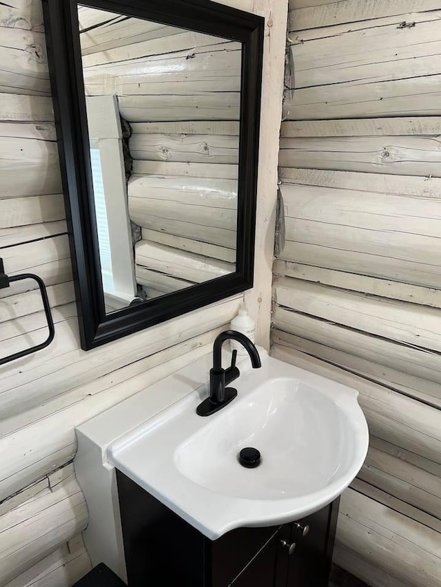 bathroom with vanity and wooden walls
