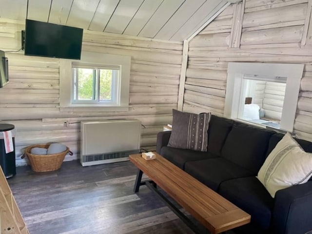living area featuring heating unit, rustic walls, wood ceiling, vaulted ceiling, and wood finished floors