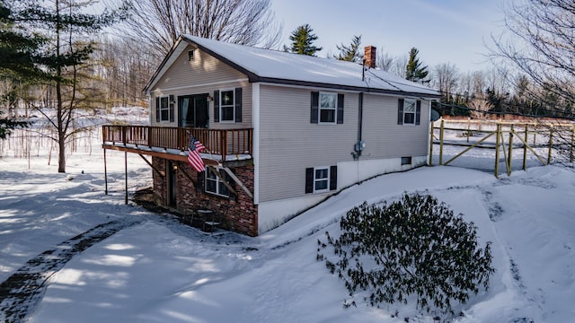 view of snow covered exterior featuring a deck