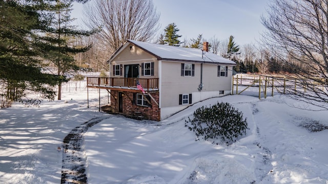 view of snow covered exterior with a deck