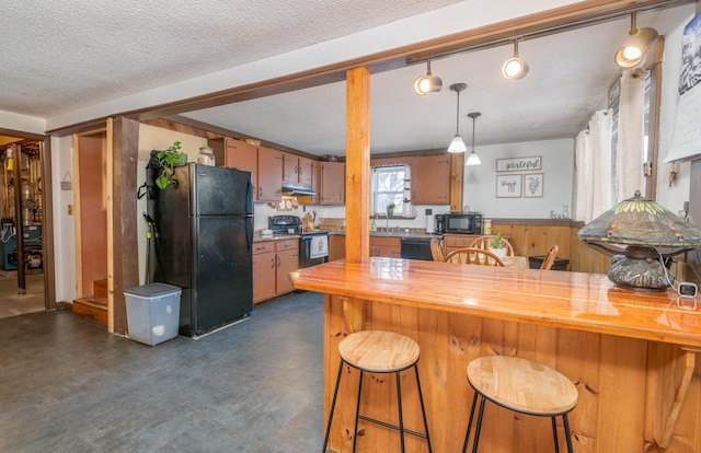 kitchen with a textured ceiling, black appliances, wooden counters, and kitchen peninsula