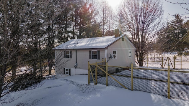 view of snow covered back of property