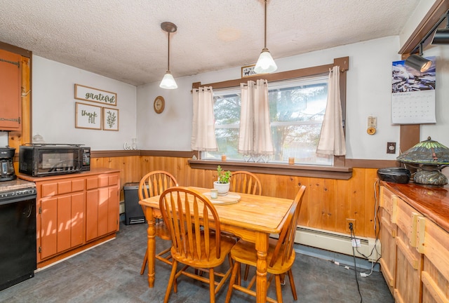 dining room featuring a baseboard heating unit, a textured ceiling, and wooden walls