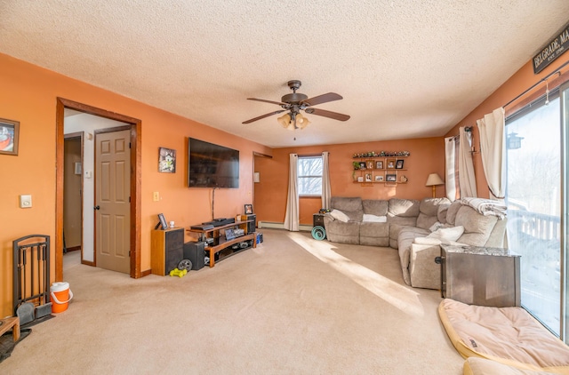 living room featuring ceiling fan, light colored carpet, and a textured ceiling