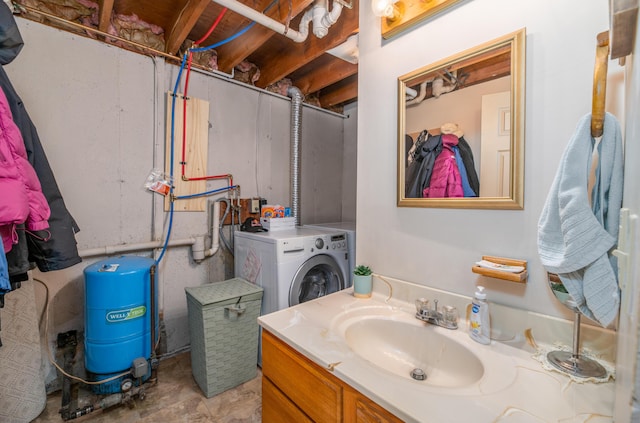 bathroom featuring vanity and washer / dryer