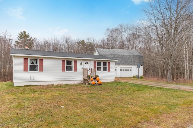 view of front of house featuring a garage and a front lawn