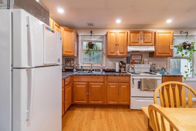 kitchen featuring white appliances, sink, and light wood-type flooring