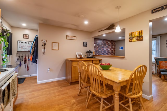 dining space with light hardwood / wood-style floors