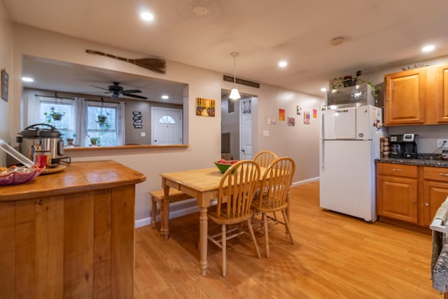 dining room with ceiling fan and light wood-type flooring