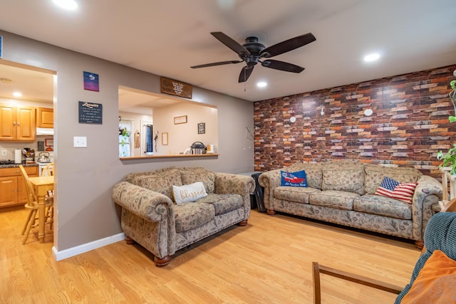 living room with ceiling fan and light hardwood / wood-style floors