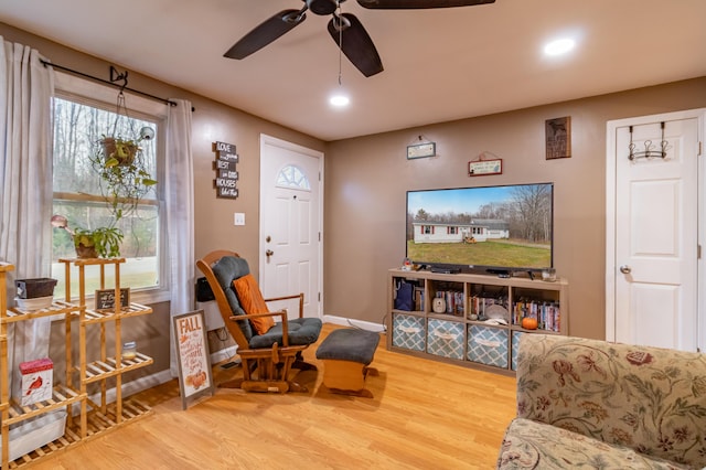 sitting room with wood-type flooring and ceiling fan