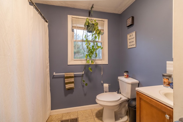 bathroom with tile patterned flooring, vanity, and toilet