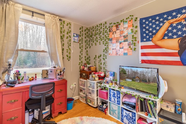 office with a textured ceiling and light hardwood / wood-style floors