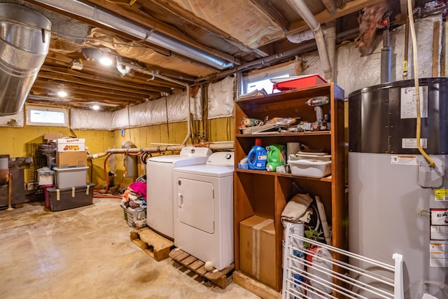 basement featuring water heater and independent washer and dryer