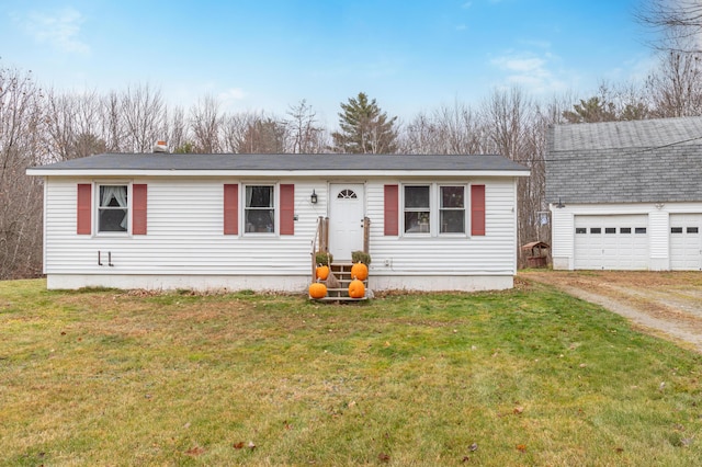 manufactured / mobile home with a garage and a front lawn