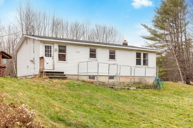 back of house featuring a yard