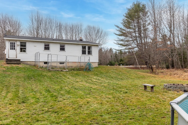 rear view of property with a lawn