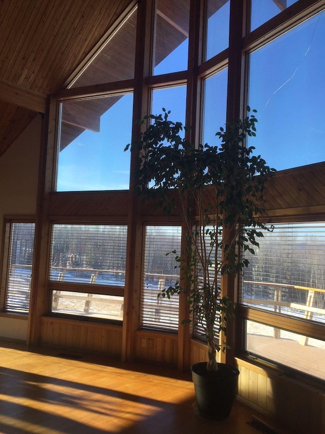 unfurnished sunroom featuring lofted ceiling