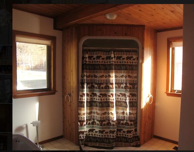 wine room with beamed ceiling and wooden ceiling