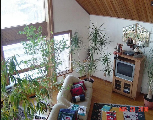 living room with vaulted ceiling, hardwood / wood-style floors, and wooden ceiling