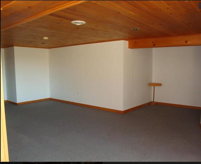 unfurnished room featuring carpet and wooden ceiling